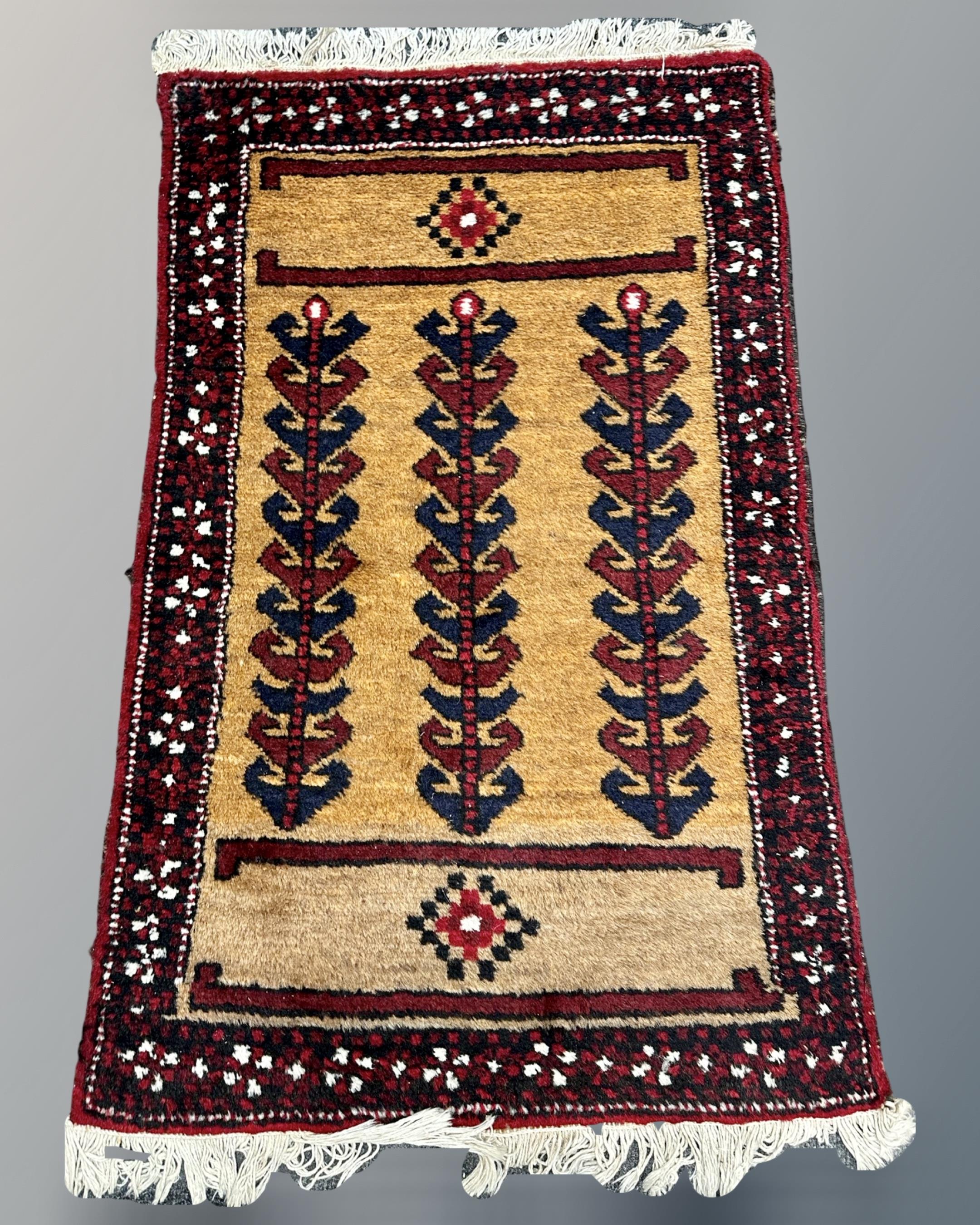 A Caucasian rug, 64cm by 103cm.