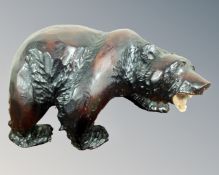 A carved wooden figure of a grizzly bear.