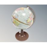A mid century desk globe on stand