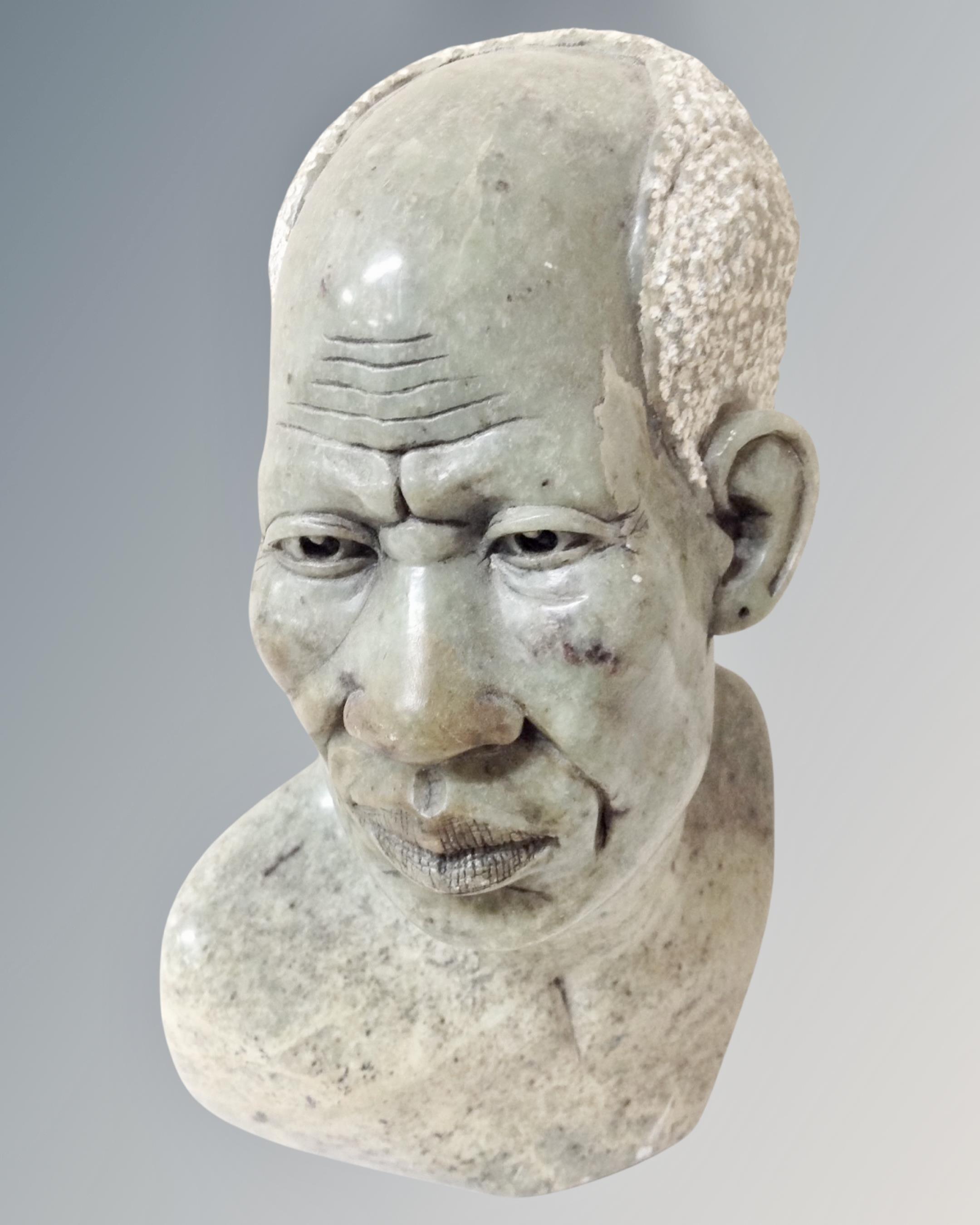 A carved marble bust of a gentleman.