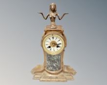 A 19th century painted metal and marble 24 hour mantel clock surmounted by an Egyptian figure