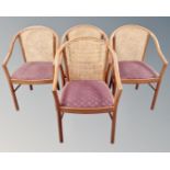 A set of four bergere elbow chairs.