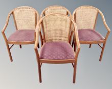 A set of four bergere elbow chairs.