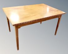 A Scandinavian teak pull out rectangular dining table.