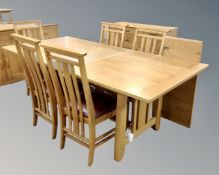 A contemporary oak extending table with two leaves and a set of six chairs.
