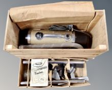 A vintage Vactric model W-202 cylinder vacuum in a plywood box.