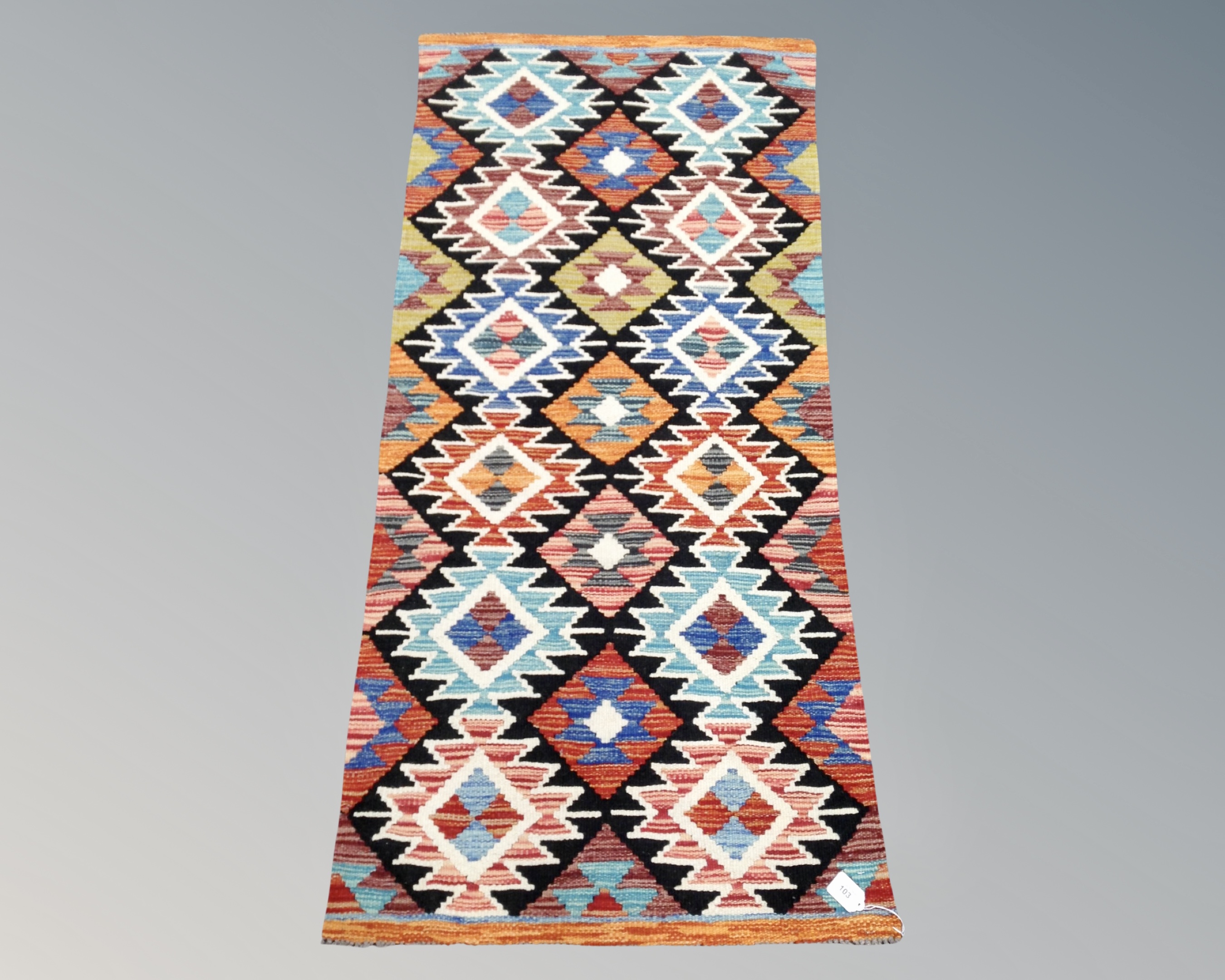 A Chobi Kilim runner, 142cm by 68cm.