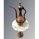 An antique Middle Eastern copper and brass teapot together with an eastern brass circular marble
