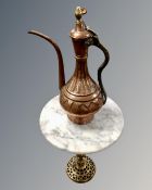 An antique Middle Eastern copper and brass teapot together with an eastern brass circular marble