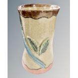 An S. Hollingsworth studio pottery vase decorated with leaves.