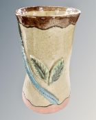 An S. Hollingsworth studio pottery vase decorated with leaves.