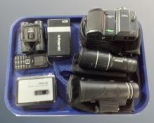 A tray containing a Nikon camera, Panda field glasses, two spotting scopes, cassette Walkman.