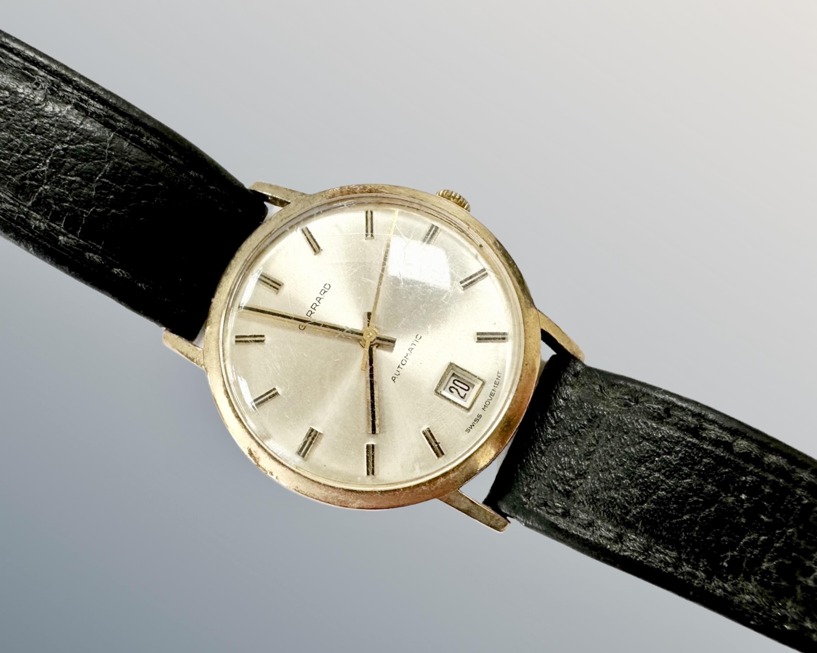 A gent's 9ct gold Garrard automatic centre seconds calendar wristwatch, inscription to case back,