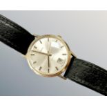 A gent's 9ct gold Garrard automatic centre seconds calendar wristwatch, inscription to case back,