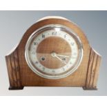 A 1930s oak cased eight-day mantel clock.