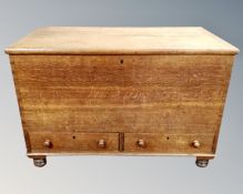 A 19th century oak blanket chest fitted with two drawers beneath.