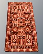 An Afghan design rug, 98cm by 170cm.