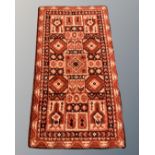 An Afghan design rug, 98cm by 170cm.