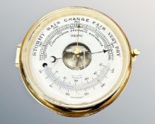 A brass circular-cased Westo barometer, diameter 18cm.
