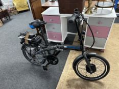 An Apollo transport folding electric bike, with instructions and charger.