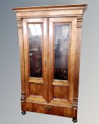 A 19th century double door glazed bookcase on bun feet