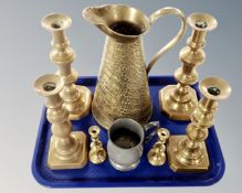 A tray containing three pairs of antique brass candlesticks together with a brass jug and an old