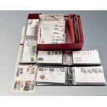 Stamps: A box containing four albums and a quantity of loose first day covers,