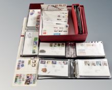 Stamps: A box containing four albums and a quantity of loose first day covers,