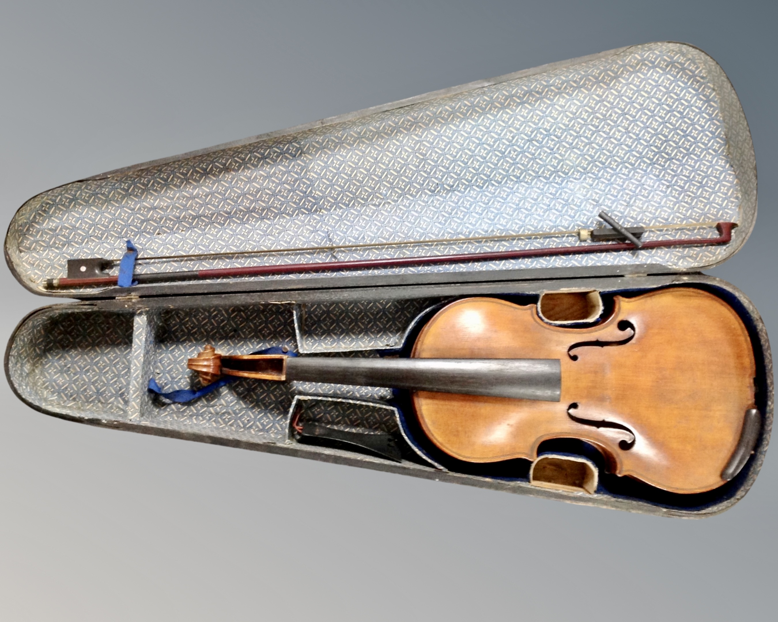 An antique violin and bow in coffin case, bearing label D. Lindsey violin maker, Gateshead.