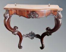 A carved hall table with scroll legs