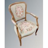 A continental carved beech salon armchair with embroidered seat.