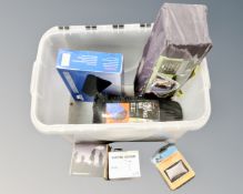 A box containing camping equipment including two person tent, sleeping bag, digital filter kit,