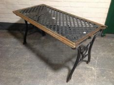 A wrought iron and wood refectory garden table