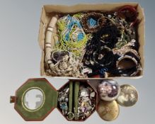 A tray containing a quantity of costume jewellery, beaded necklaces, compacts, dress rings etc.