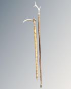 Two antler-handled walking sticks, longest 135cm.