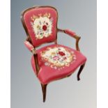 A continental carved beech salon armchair with embroidered seat.