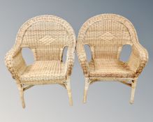 A pair of wicker armchairs.