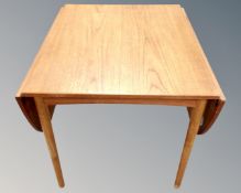 A 20th century Scandinavian teak drop leaf extending dining table.
