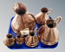 A set of six Portuguese graduated copper measuring jugs.