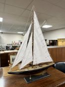 A model yacht on stand.
