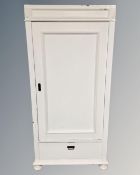 A 19th century painted pine sentry door cabinet fitted with a drawer beneath.