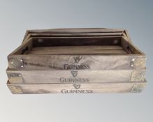 A set of three graduated wooden Guinness branded trays.