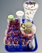 A tray containing assorted glassware including pearlescent bird ornament, two tone wine glasses,