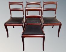 A set of four reproduction mahogany ladderback dining chairs.