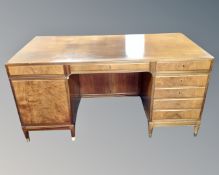 A 20th century Scandinavian teak twin pedestal writing desk fitted with cupboards and drawers.