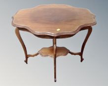 An Edwardian shaped two tier occasional table.