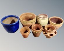 A large glazed pottery garden pot and assorted terracotta plant pots
