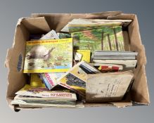 A box containing a quantity of cigarette and tea card albums and cards.