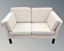 A late 20th century Scandinavian two seater settee in oatmeal fabric.