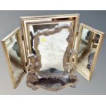 A gilt Rococo style dressing table mirror on stand together with a further gilt triple dressing